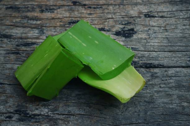 istock Aloe Vera Cuts Isolated on Wooden Background 1254094274
