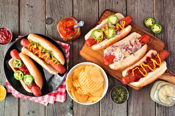 istock BBQ hot dog table scene, above view over dark wood 1254095704