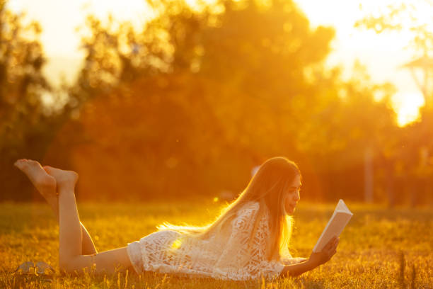 istock young woman studying on the grass at sunset 1254108830