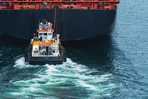 A container ship departs a harbour on the East coast.