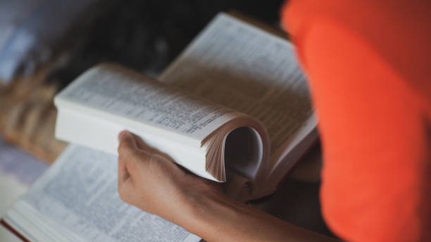istock Teenager reading book 1254111213