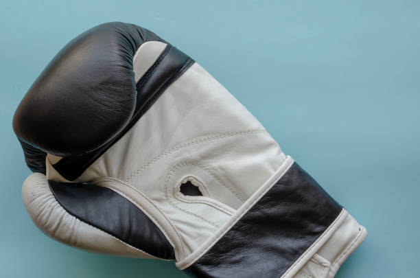 istock New leather boxing glove on blue background. 1254113924