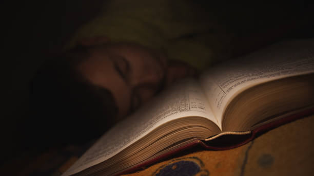 istock Teenager falling a sleep while reading a book 1254113980