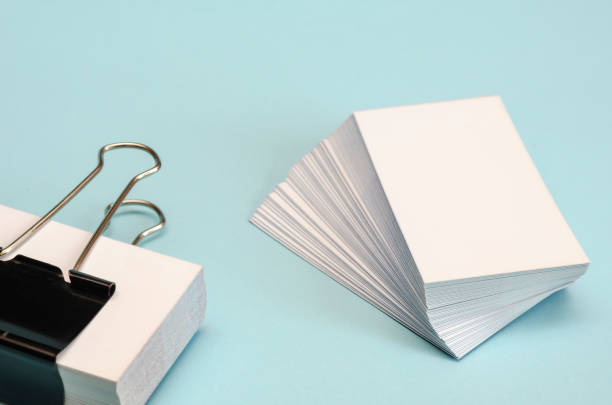 istock Blank business cards on a light turquoise background. 1254114071