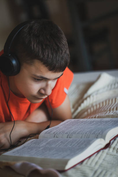 istock Teenager reading book 1254115179