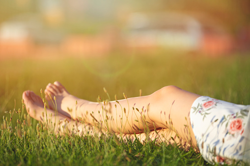 young beautiful woman stretching on the grass