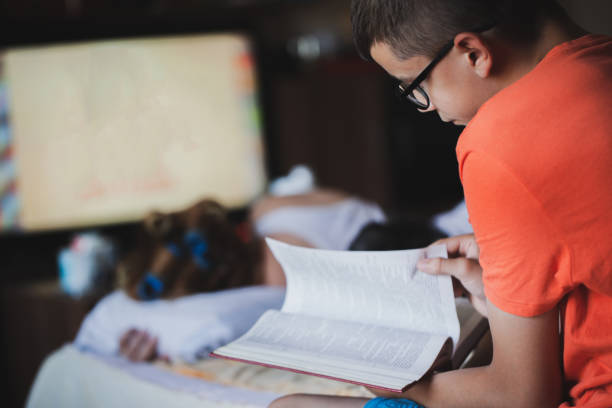 istock Teenager reading book 1254115260