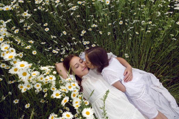 istock mother with daughter in a white dress 1254120522
