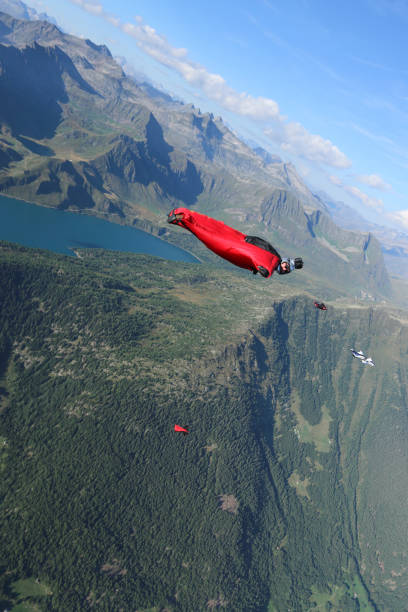 istock Wing suit fliers soar over Swiss Alps 1254122931