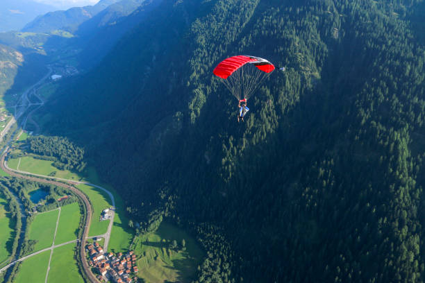 istock Paraglider soars over Swiss Alps 1254124764