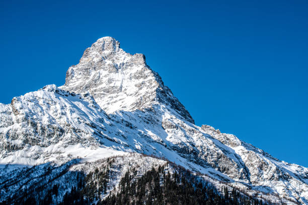 istock Clear blue sky over snowy mountain peak 1254125269