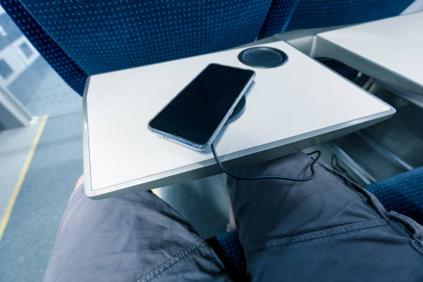 istock charging the phone when traveling by train.  Wireless charger 1254126487