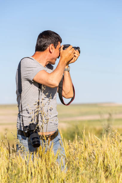 istock Photographer at Wheat Field 1254136849