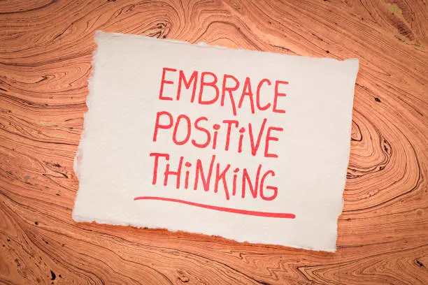 embrace positive thinking - inspirational handwriting on a handmade rag paper, education and personal development concept