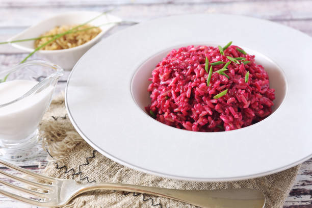 istock Pink rice. Beetroot risotto from brown rice with almond milk 1254137013