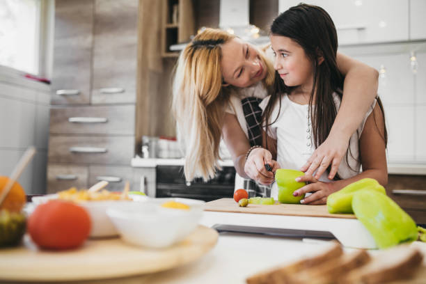 istock Mother and daughter having fun with the vegetables 1254137766