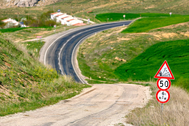 istock asphalt and gravel road 1254137848
