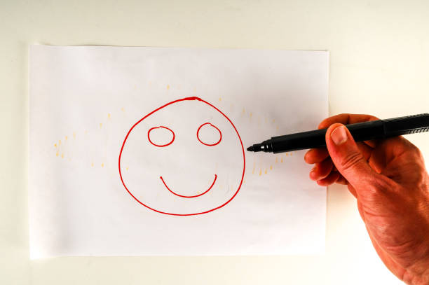 istock Close-up of sheet with drawing face 1254138870