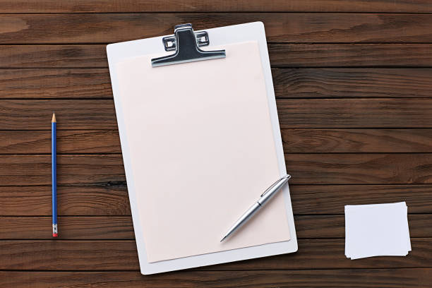 istock Clipboard with Blank Paper on a Wooden Background 1254139062