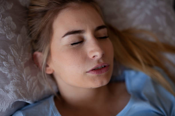 Bruxism, teeth clenching or grinding and mouth breathing during sleep stock photo