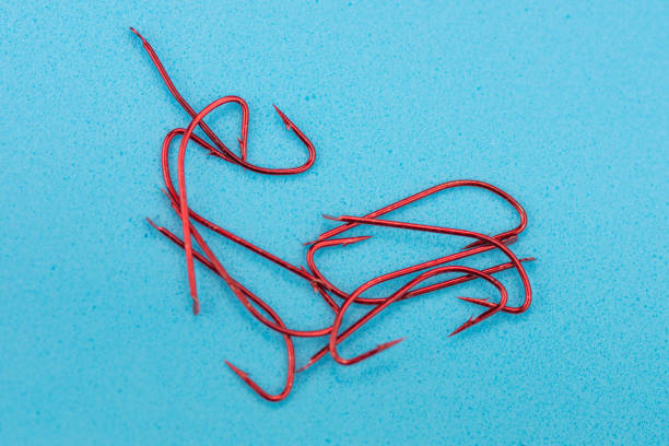 istock Steel fishing hooks on a white background 1254139812