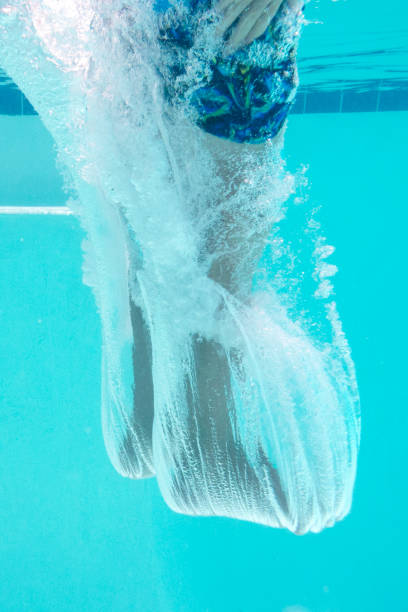 istock Moment After Entry When Jumping into a Crystal Clear Pool Feet First 1254141574
