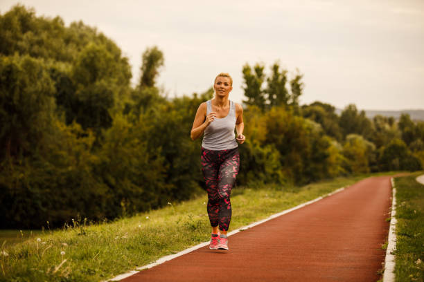 istock Female athlete practicing her running on a track 1254143344