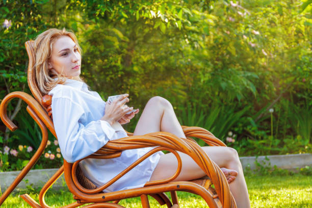 istock Young beautiful blonde woman relaxing at backyard 1254144588