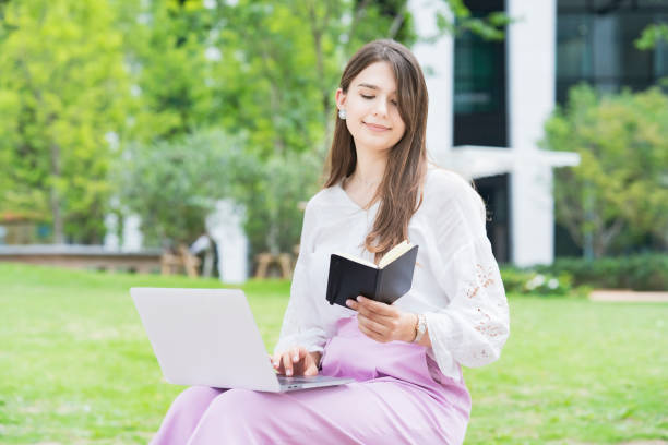 istock Young business woman looking at schedule book 1254151711