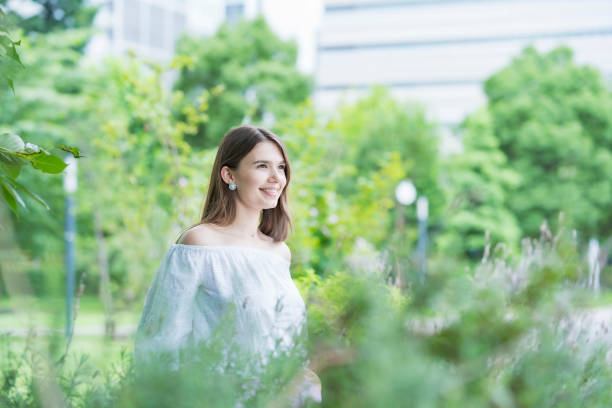 istock Young woman walking in the park 1254152726