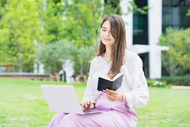 istock Young business woman looking at schedule book 1254153598