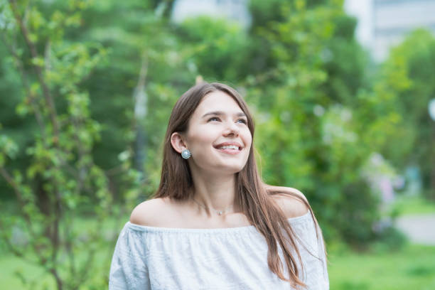 istock Young woman walking in the park 1254153850