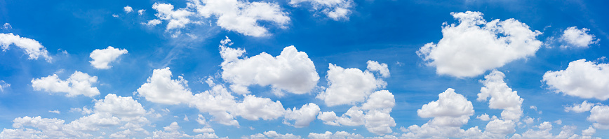 Cumulus clouds appear in a blue sky over Kachina Wetlands near Flagstaff, Arizona, USA.