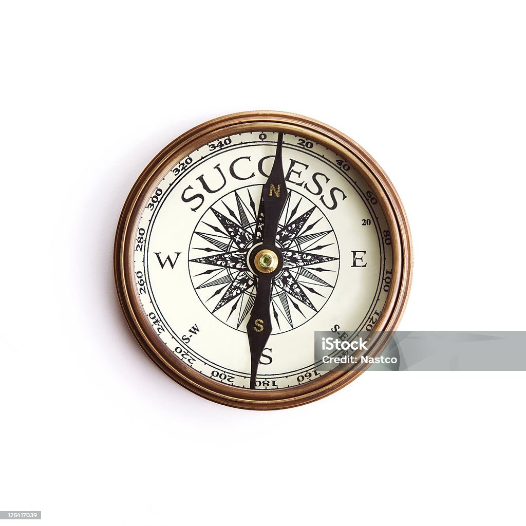 The way to success concept, isolated with clipping paths Vintage brass compass with arrow pointed to the success sign Close-up Stock Photo