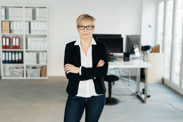 istock Smart business executive standing with folded arms 1254171580