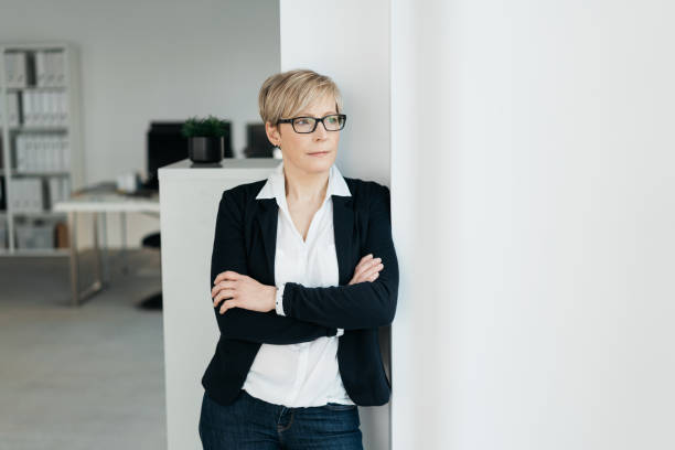 istock Thoughtful businesswoman watching through a window 1254171599