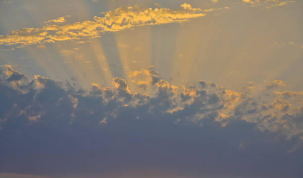 istock sun rays push through a dense cumulus clouds, beautiful natural sky background 1254172848