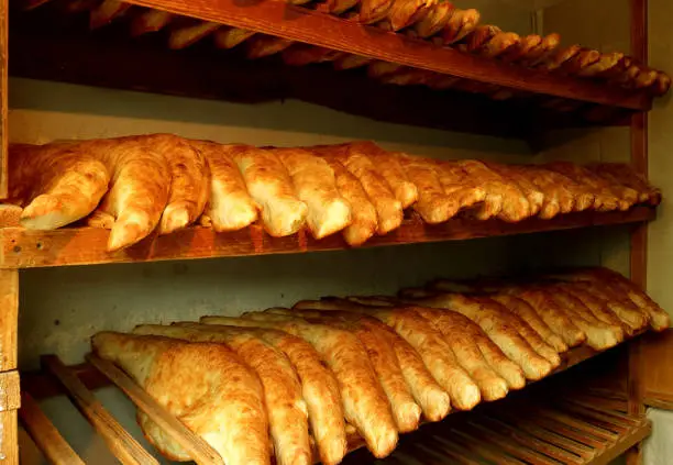 Photo of Traditional Georgian Bread Called Shotis Puri or Shoti on the Wooden Lack of a Local Bakery in Georgia