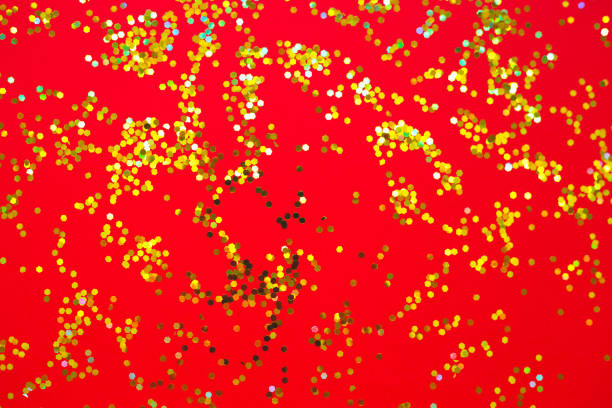 istock yellow and red sparkles on a red background 1254175230