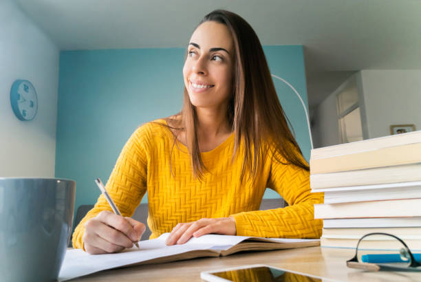 istock Happy female student studying at home 1254180219