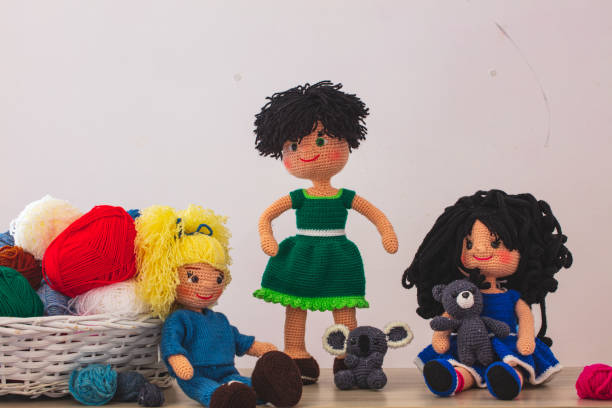 istock Cute wool dolls are lying on the table 1254181382
