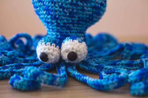 istock Cute wool dolls are lying on the table 1254181394