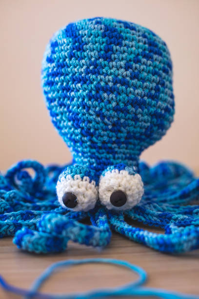 istock Cute wool dolls are lying on the table 1254181401