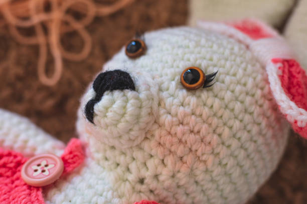 istock Cute wool dolls are lying on the table 1254181403