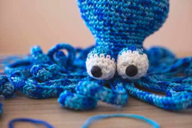 istock Cute wool dolls are lying on the table 1254181407