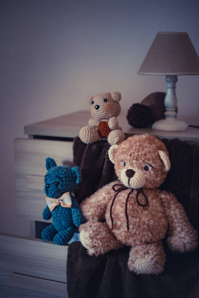 istock Cute wool teddy bears are lying on the table 1254181468
