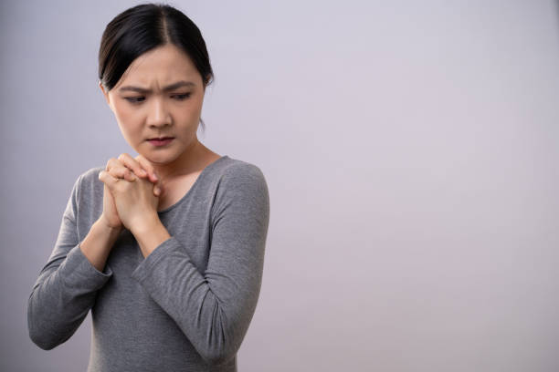 istock Asian woman thinking about problem, worried and confused emotion isolated on background. 1254183916