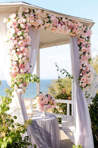 istock Wonderful wedding arch decorated by roses 1254185762