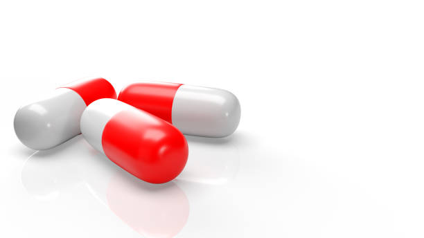 istock red white capsule 3d rendering for medical content. 1254186805