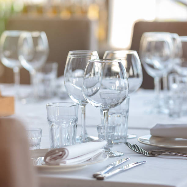 istock Empty glasses in restaurant background. Table set for an event party or wedding reception. 1254189300